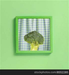 Broccoli in a green square frame. Summer monochrome look. Minimal healthy food abstract concept. Square with copy space. Broccoli in a green square frame