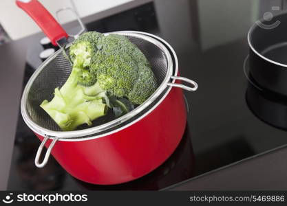 Broccoli in saucepan on stove at kitchen