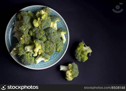 broccoli on a black background. summer harvest 