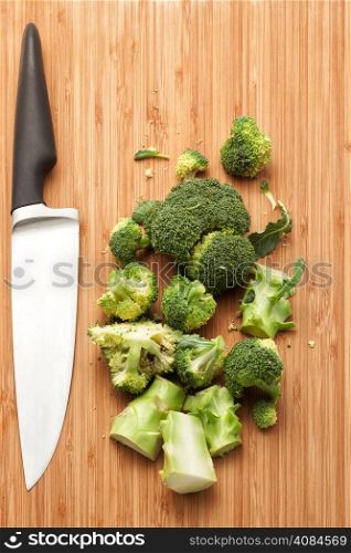 Broccoli on wooden board with kitchen knife