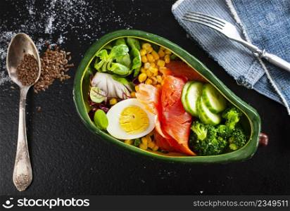 broccoli salnon and boiled egg in ceramic bowl served with corn and seeds