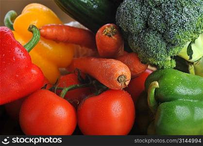 broccoli, tomatoes, carrots and cucumber lie in basket
