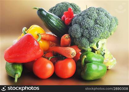 Broccoli, Tomatoes, carrots and cucumber lie on table