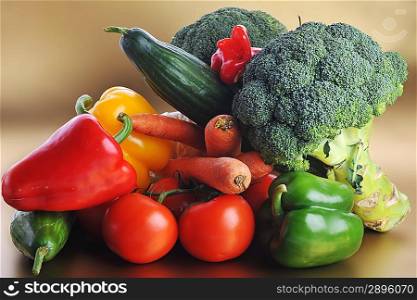 broccoli, tomatoes, carrots and cucumber lie on table
