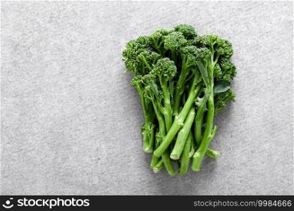 Broccolini. Fresh bunch of broccoli sprouts on a cooking table. Healthy food concept. Top view