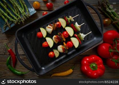 brochette grill with tomato onion pepper zucchini. brochette vegetable on grill pan with tomato onion pepper zucchini