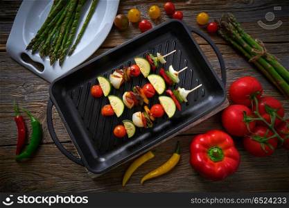 brochette vegetable on grill pan with tomato onion pepper zucchini. brochette grill with tomato onion pepper zucchini