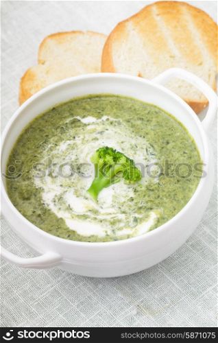 Brocolli cream soup in a white bowl. Brocolli cream soup