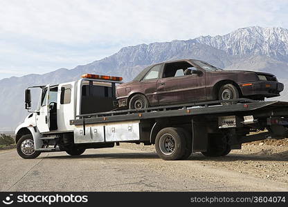 Broken car on tow truck