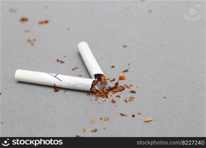 broken cigarette on a gray background close. stop smoking concept. broken cigarette on gray background close. stop smoking concept