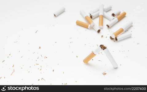 broken cigarette tobacco white surface