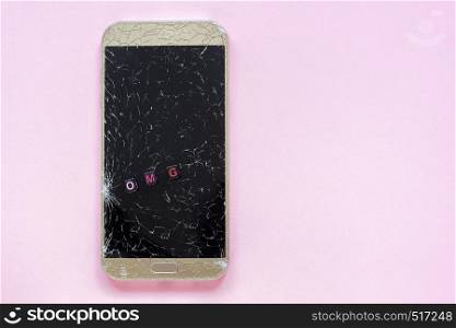 Broken cracks mobile phone and text OMG on pink background Concept Copy Space Top view. Broken cracks mobile phone and text OMG