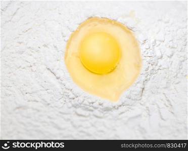 Broken egg on flour, means for making bread. Broken egg on flour, for making bread