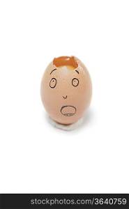 Broken egg with face drawn on it over white background