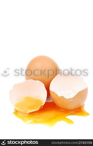 broken egg with the yolk and white oozing out isolated on white background