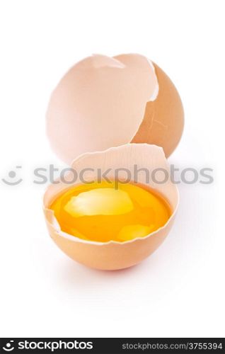Broken egg with yolk and eggshell on white background