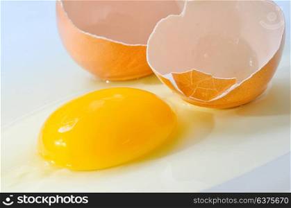 Broken fresh egg isolated on white table