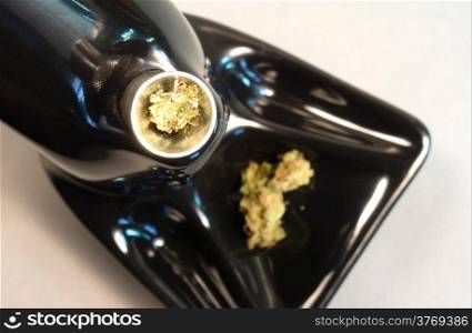 Broken Green Buds sitting in the bowl before a smoke