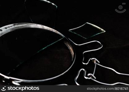 broken mirror pieces on a black background close-up