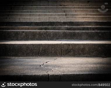 Broken old concrete staircase with cracked background texture