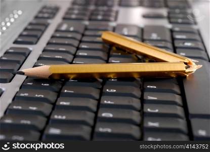 broken pencil on a keyboard