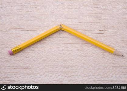 broken pencil on wooden board