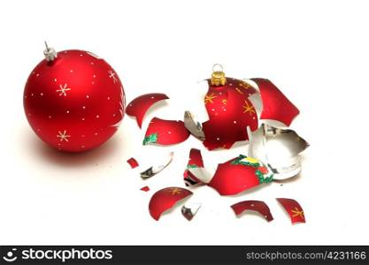 Broken red christmas ball and safe one isolated on white background