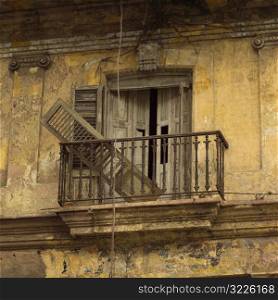 Broken shutter in a balcony, Havana, Cuba