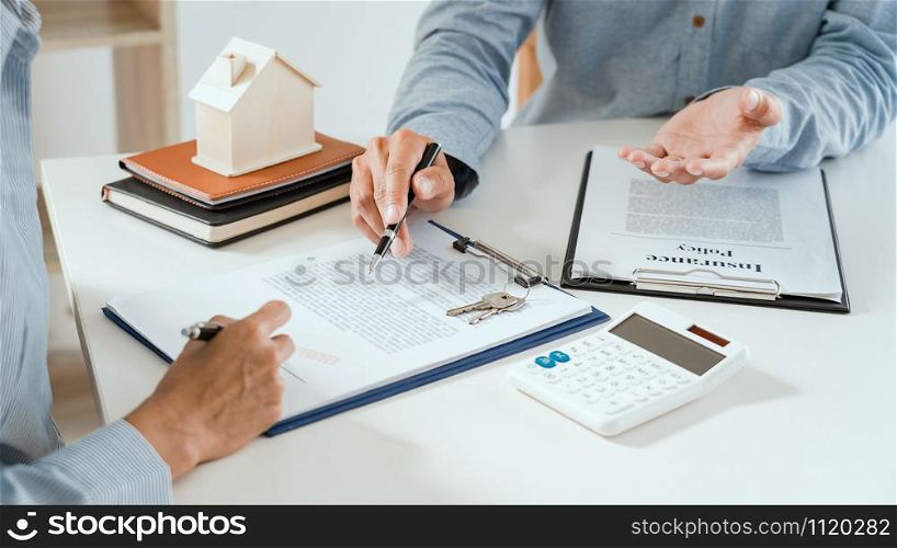 broker agent and customer holding pen, the policyholder and explain discussing for concerning mortgage loan offer for and house insurance