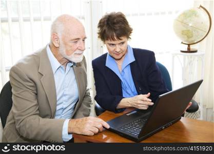 Broker and client using a computer to view his assets online.