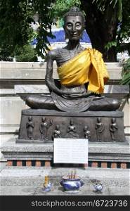 Bronze Buddha in the inner yard of wat Suthat in Bangkok, Thailand