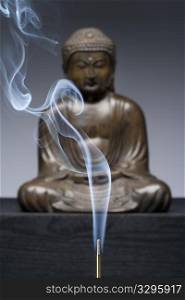Bronze Buddha Statue With Burning Incense Smoke