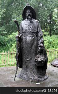 Bronze statue of old chinese saint in park, Chengdu, China