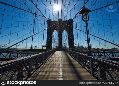 Brooklyn bridge pillar with sun back light, New York City, USA