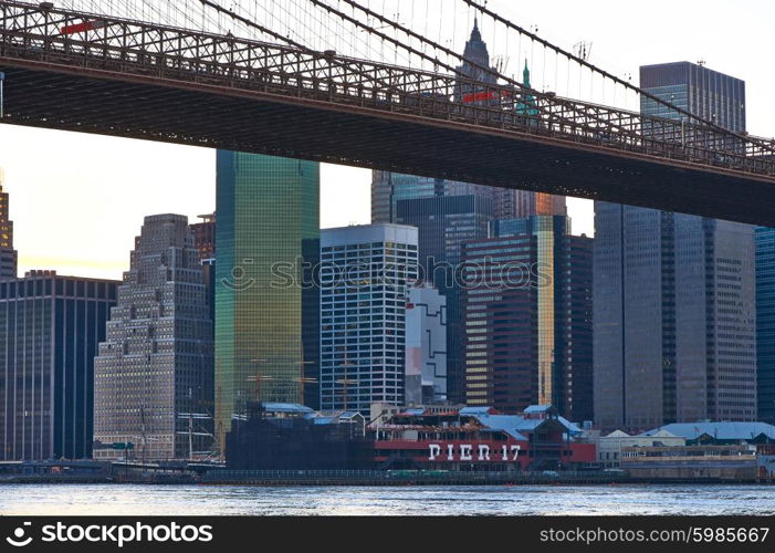 Brooklyn Bridge with lower Manhattan skyline in New York City at evening