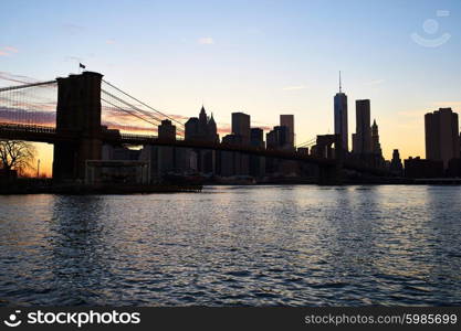 Brooklyn Bridge with lower Manhattan skyline in New York City at evening