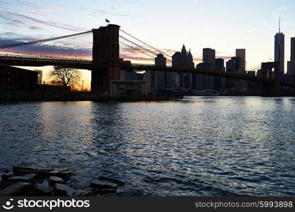 Brooklyn Bridge with lower Manhattan skyline in New York City at evening