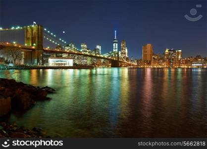 Brooklyn Bridge with lower Manhattan skyline in New York City at night