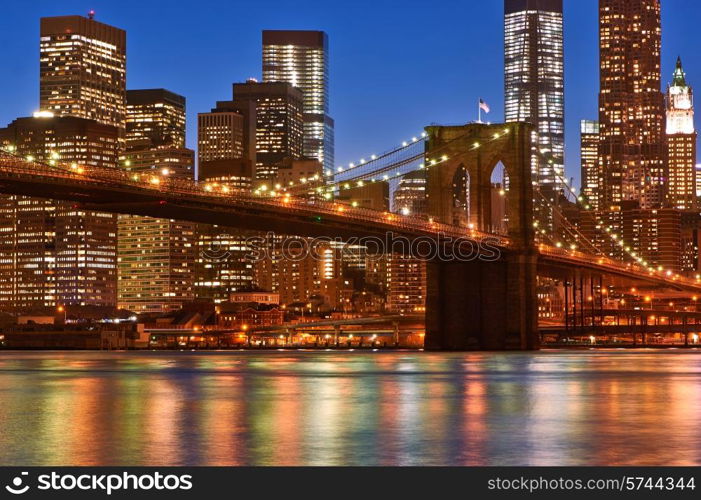 Brooklyn Bridge with lower Manhattan skyline in New York City at night