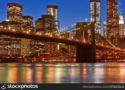 Brooklyn Bridge with lower Manhattan skyline in New York City at night