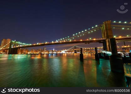 Brooklyn Bridge with lower Manhattan skyline in New York City at night