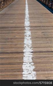 Brooklyn bridge wooden soil pavement detail way to Manhattan New York