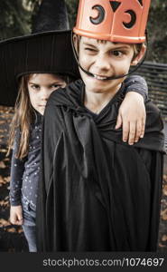 Brother and sister being silly and getting ready to go out for Halloween.