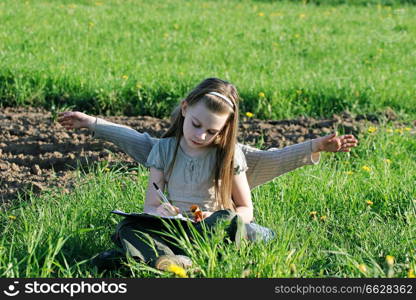 Brother and sister enjoy summer time in the green grass. 