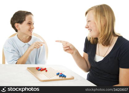 Brother and sister having fun playing board games. Isolated on white.