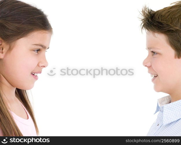 Brother and sister looking at each other smiling