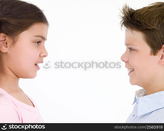 Brother and sister looking at each other smiling