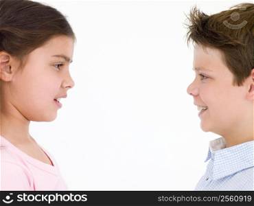 Brother and sister looking at each other smiling