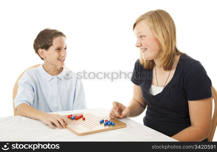 Brother and sister play a board game together. Isolated on white.
