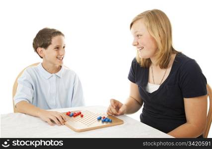 Brother and sister play a board game together. Isolated on white.